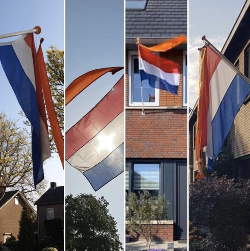 Vier wapperende Nederlandse vlaggen naast elkaar